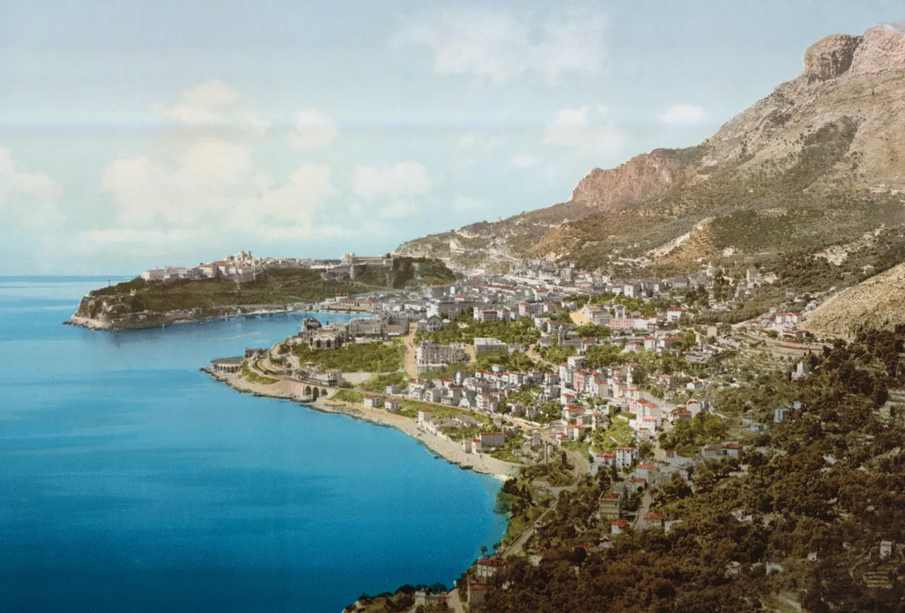 Vue de Monaco vers 1900 : le Rocher au loin, la baie et Monte-Carlo au pied de la montagne.